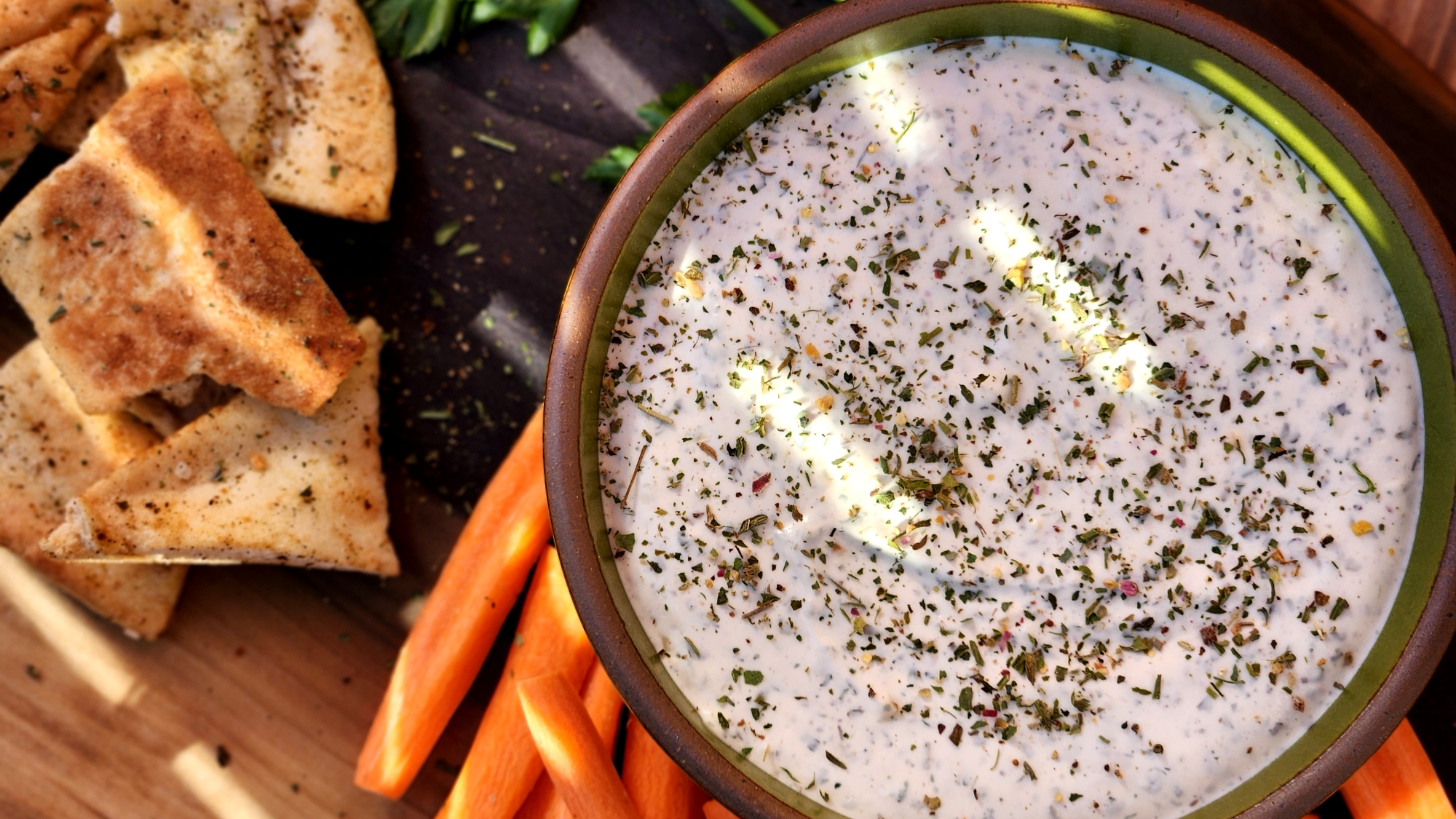 Image of Wild Green Goddess Dip with carrot sticks and pita chips.
