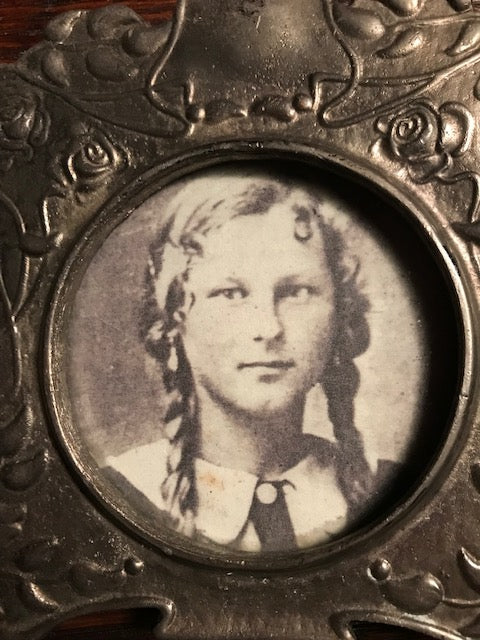 sepia toned image of girl with braids in a frame