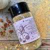 A glass jar of Magic Garlic Dust from Well Seasoned Table, a spice shop, on a wooden background.