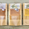Powdered beverage mixes from Well Seasoned Table in packets on a wooden background.