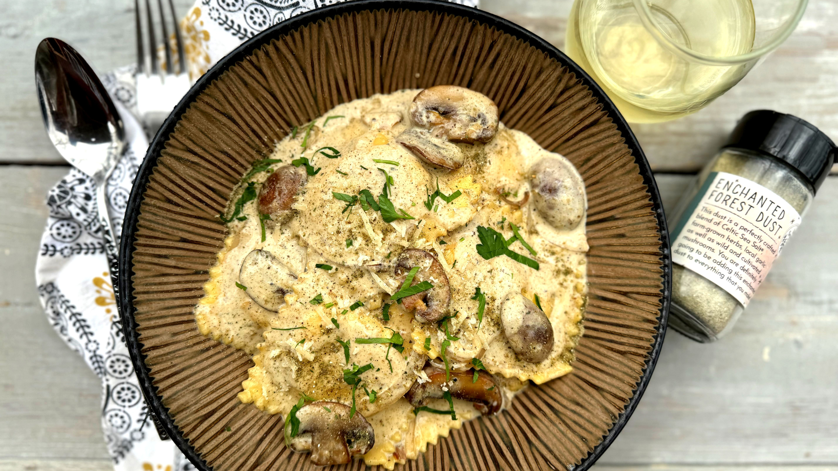 mushroom ravioli, fork, spoon, napkin, enchanted forest dust, brown bowl