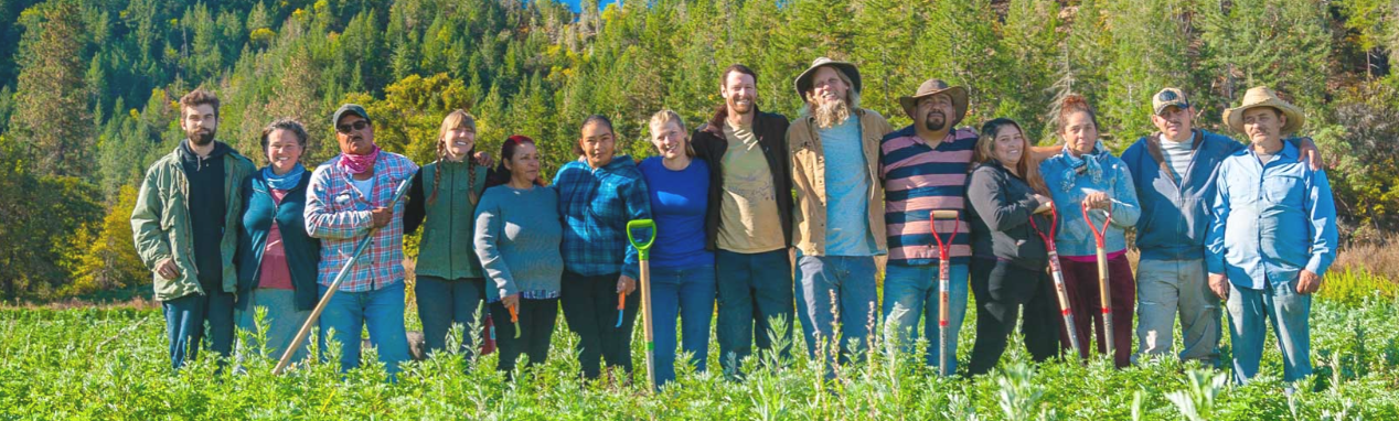 Oshala Farm Crew standing side-by-side in a field of herbs